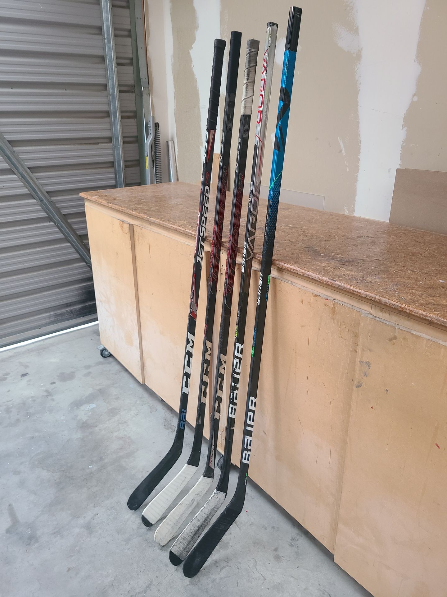 Multiple repaired ice hockey sticks
