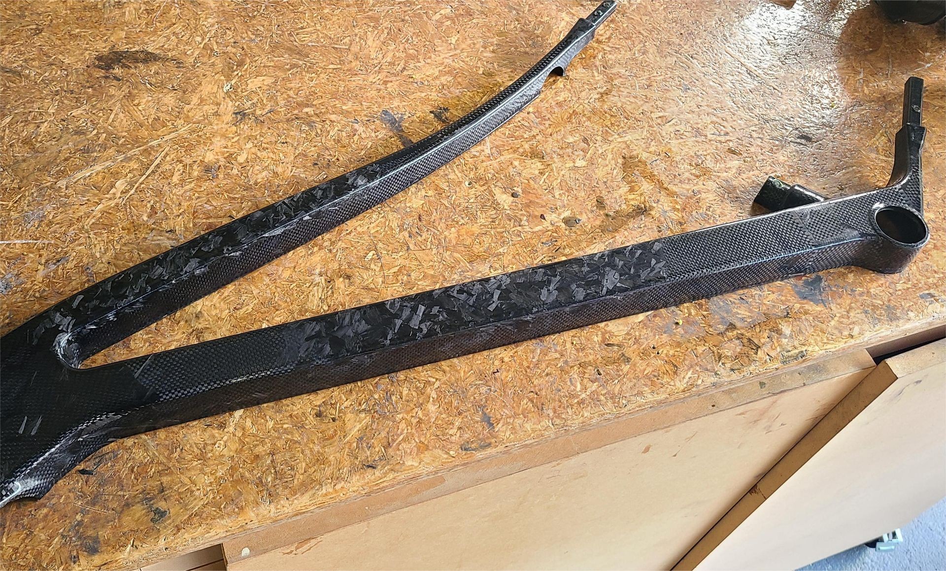 Half of a compression moulded carbon fibre front triangle 