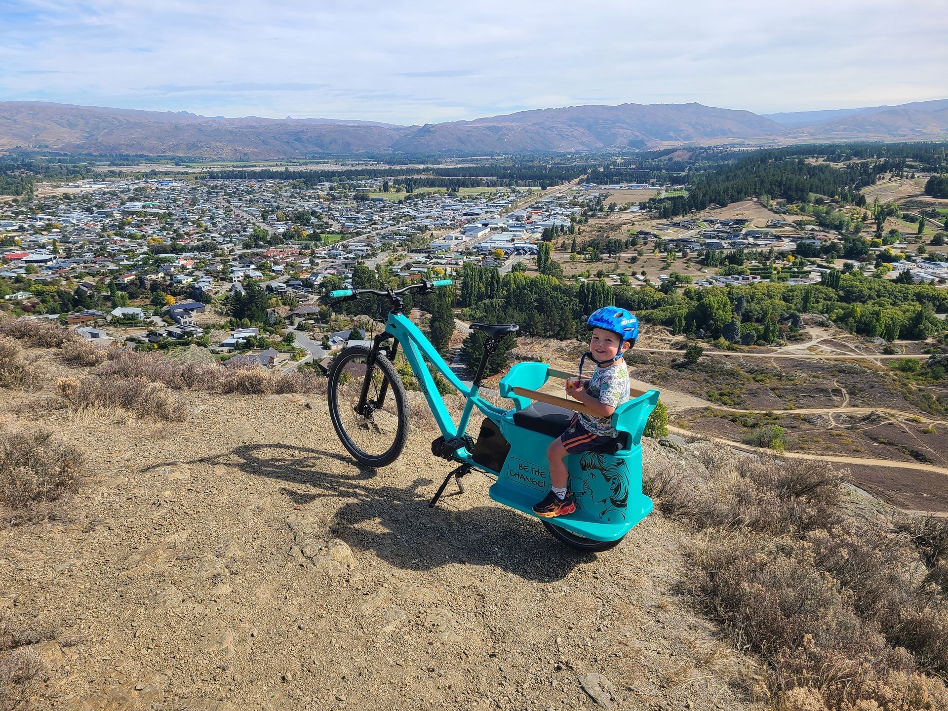 Young boy on Long John all-terrain cargo bike overlooking Alexandra, New Zealand