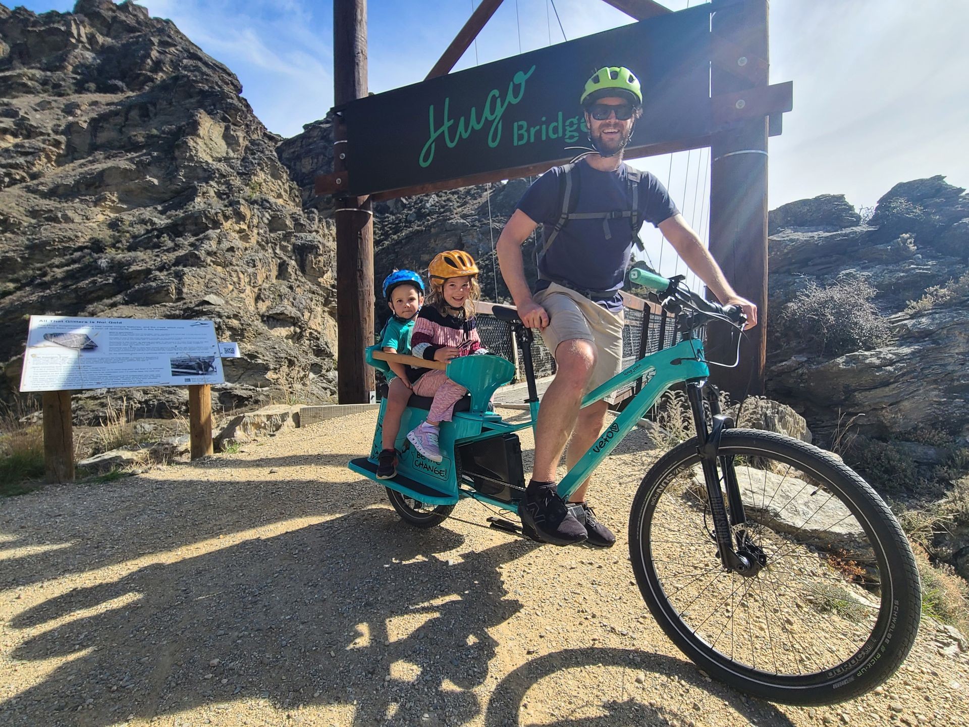 Family on the Long John all-terrain cargo bike at Hugo Bridge on the Lake Dunstan trail